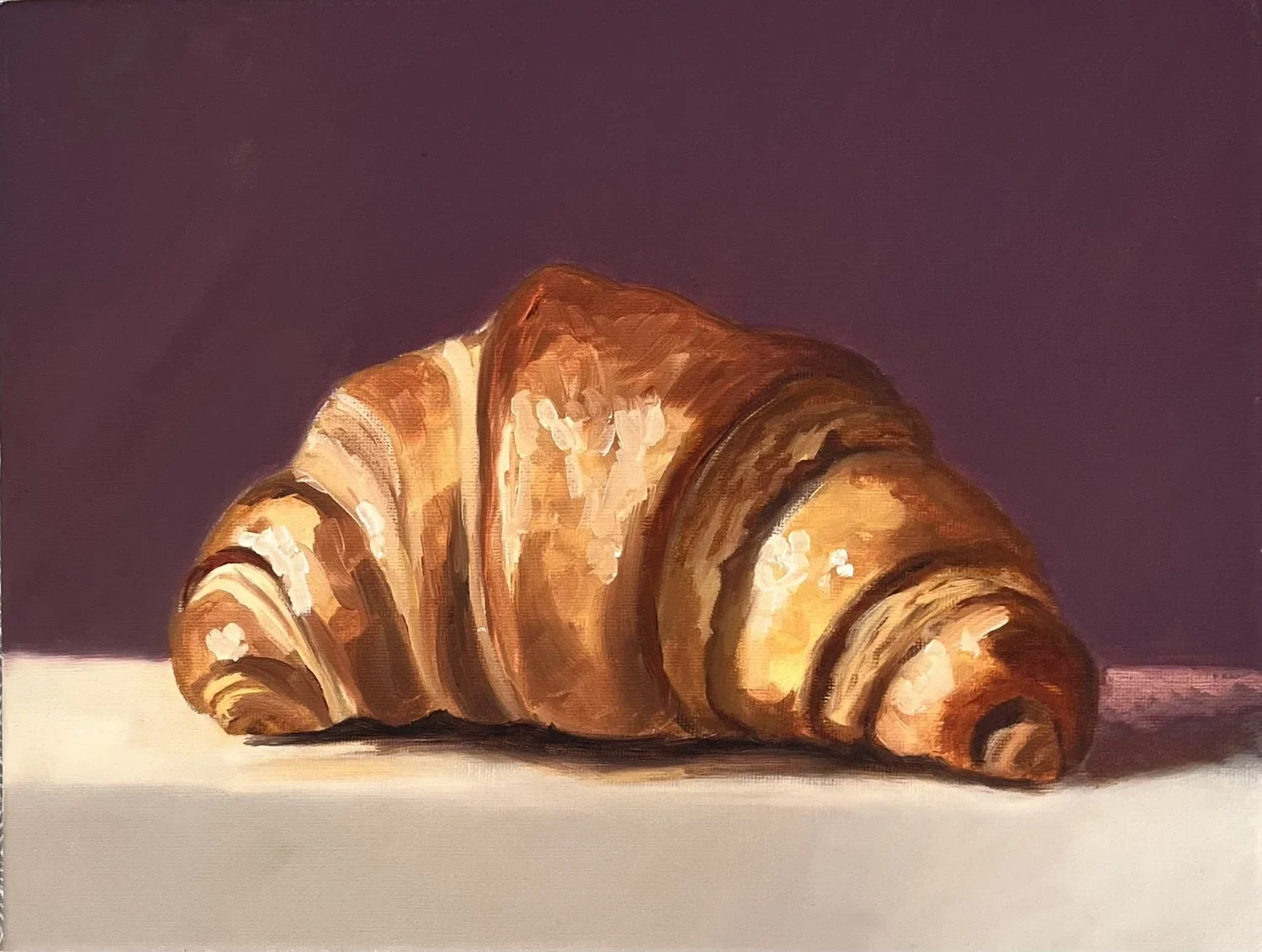 A croissant painted in warm brown tones